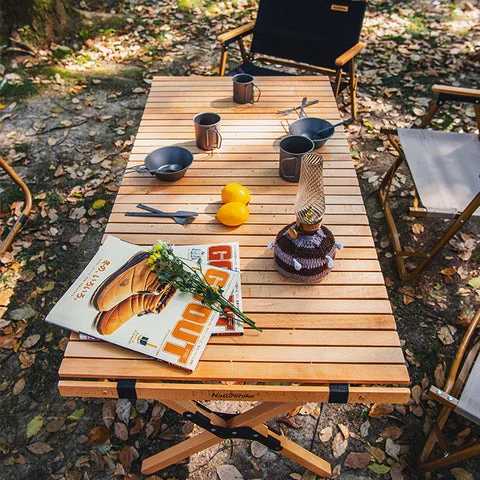 Camping kitchen setup with table, stove, and cookware