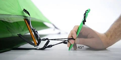 A properly pitched tent secured with pegs and guy lines.